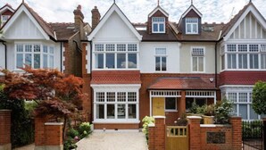 A row of two-story houses with pitched roofs, brick exteriors, and white-framed windows. - Quartz House (Richmond upon Thames)