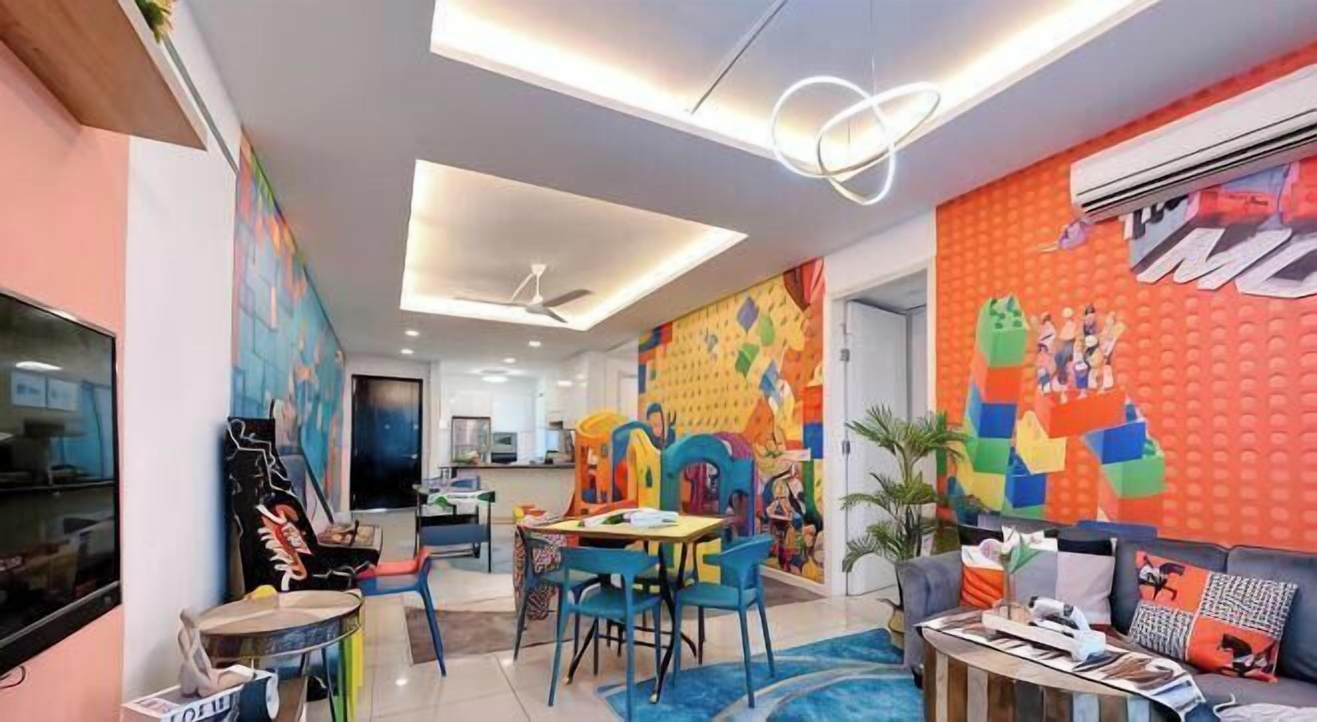 A modern interior with a dining area, colorful wall art, and a flat-screen TV.