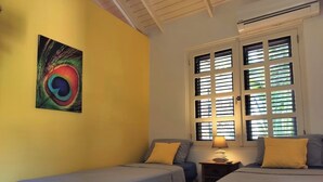 A room with two beds, a window with blinds, a wall painting, and a nightstand with a lamp. - Enjoy a spacious modern Villa, situated next to Golf Course and Pool and Beach (Sint Michiel)