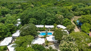 A resort with multiple villas, a swimming pool, and a beach view. - Pool, Beach, AC, Fast WiFi | Avellanas Modern Home (Playa Avellanas)