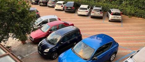 A parking lot with multiple cars parked in designated spaces.