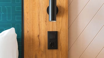 A modern room with a wooden accent wall, a small table, and a wall-mounted light fixture.