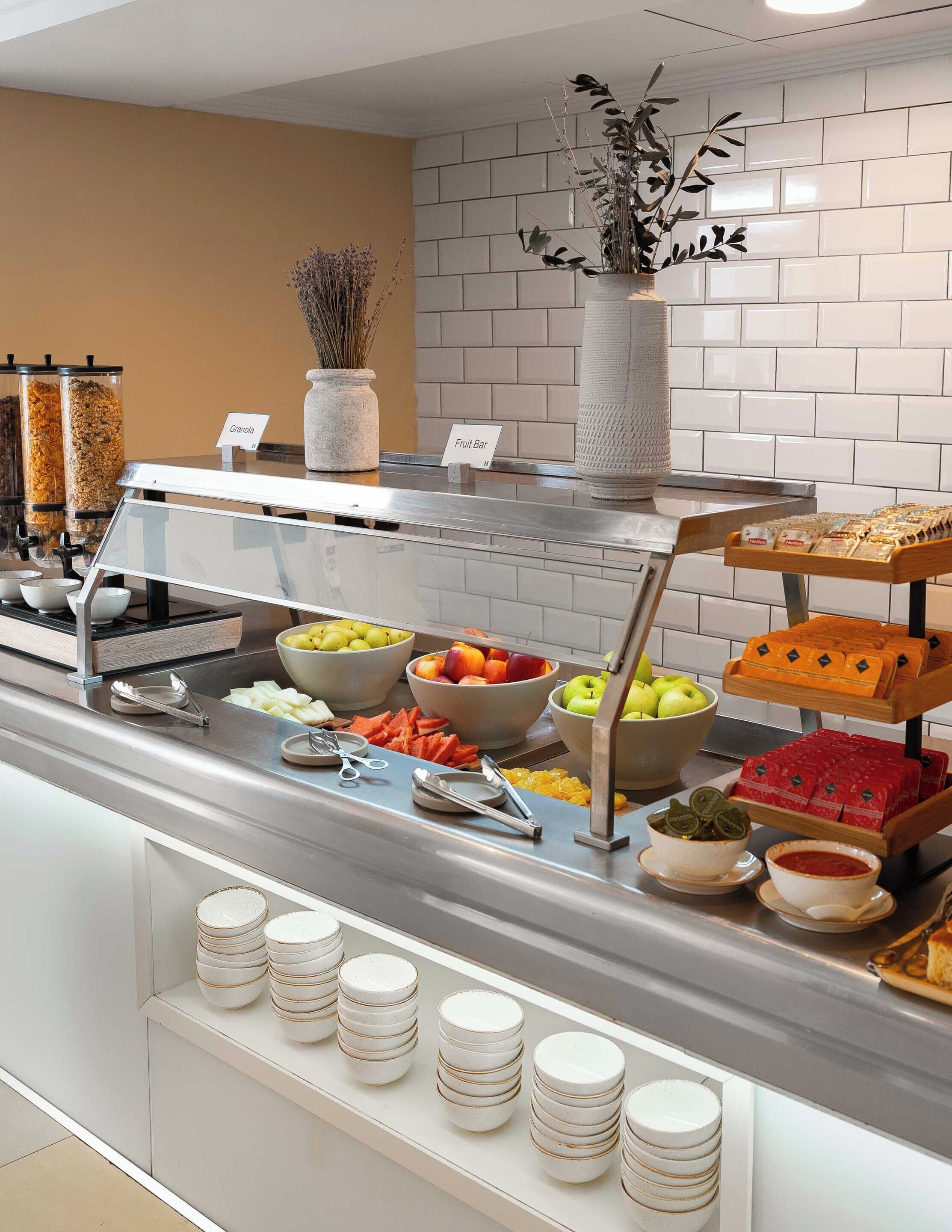 A buffet setup with various food items and condiments.
