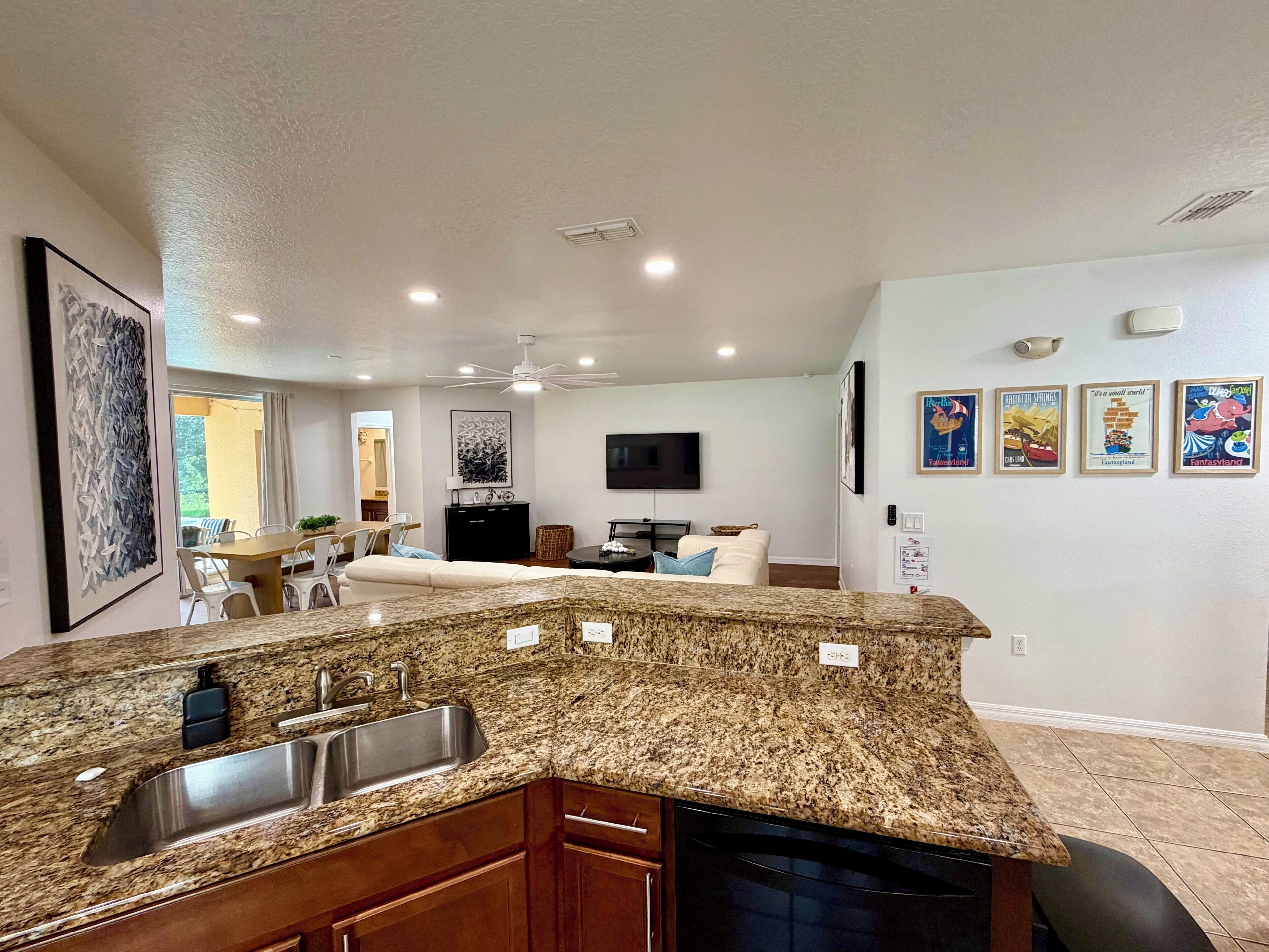 A modern kitchen with granite countertops, a built-in sink, and wooden cabinets.