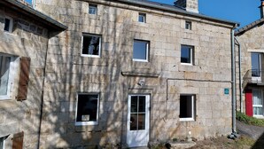 A stone building with multiple windows and a door, featuring a traditional architectural style. - Cottage “L'École Buissonnière de Mazalibrand”: Mountain View, Private Terrace & Garden (Mazet-Saint-Voy)