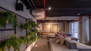 A modern interior with a sofa, a dining area, and a large window. - 4 Minutes From Arcos da Lapa M404b (Rio de Janeiro)