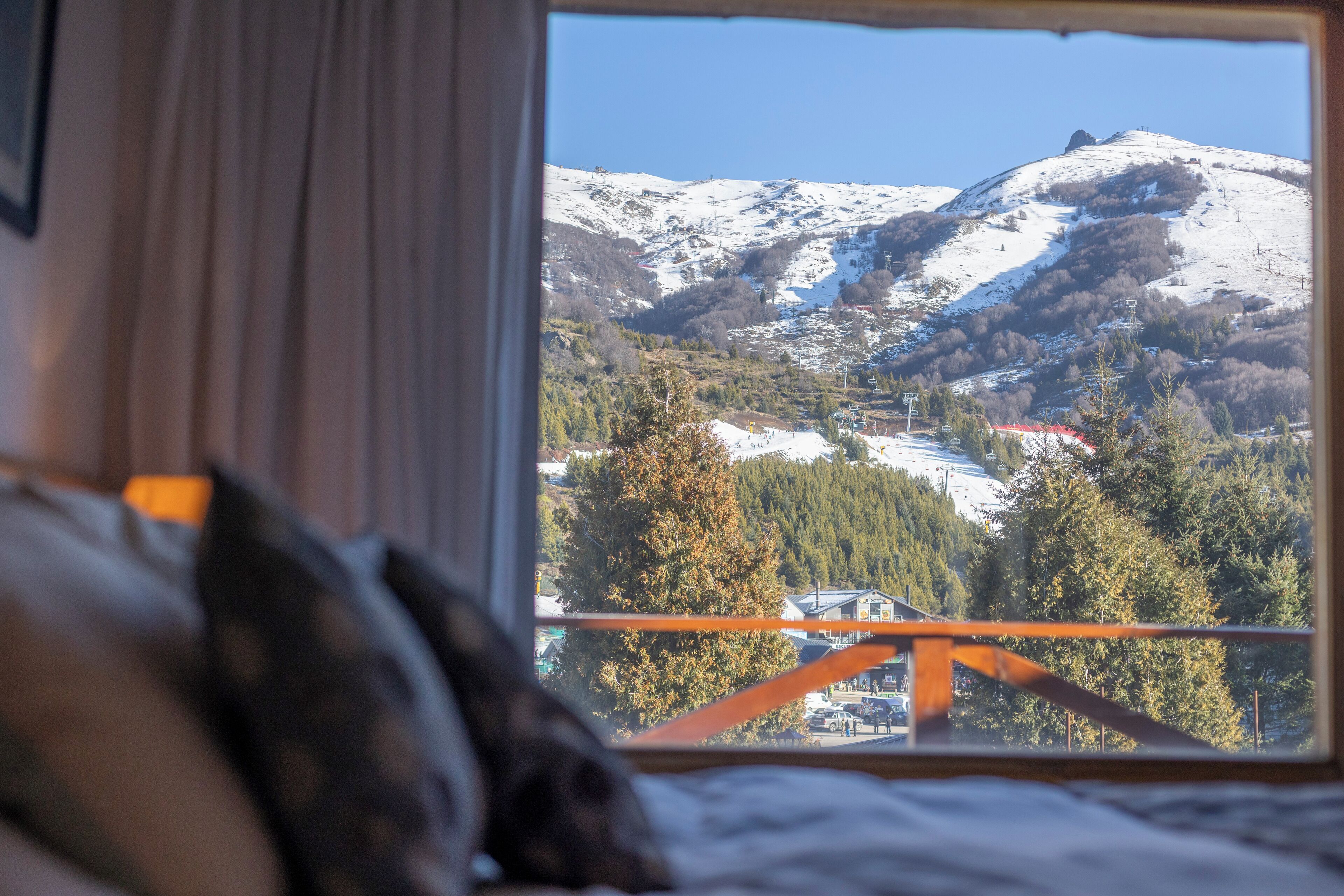 Una stanza con una finestra che si affaccia su un paesaggio montano innevato.