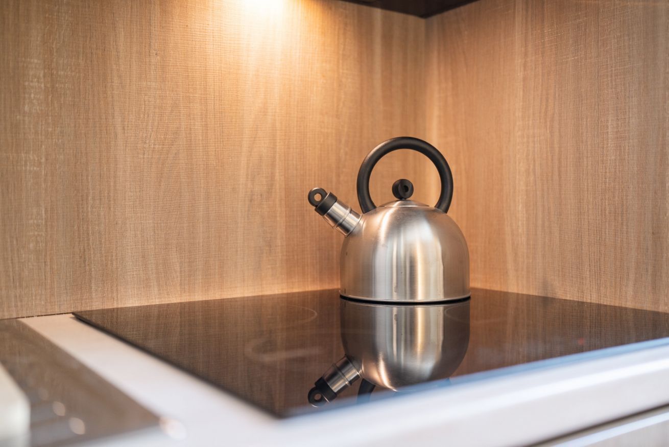 A stainless steel kettle on a modern kitchen counter.