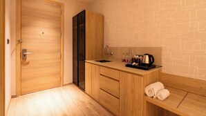 Ein modernes Badezimmer mit einem Holzbadezimmerhocker, einem Waschbecken und einem Handtuchhalter.