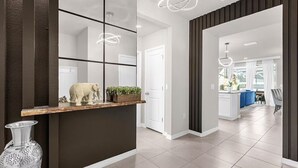A modern kitchen with a central island, a decorative elephant sculpture, and a potted plant on the counter. - Disney Retreat w/ Pool & Themed Rooms (Davenport)