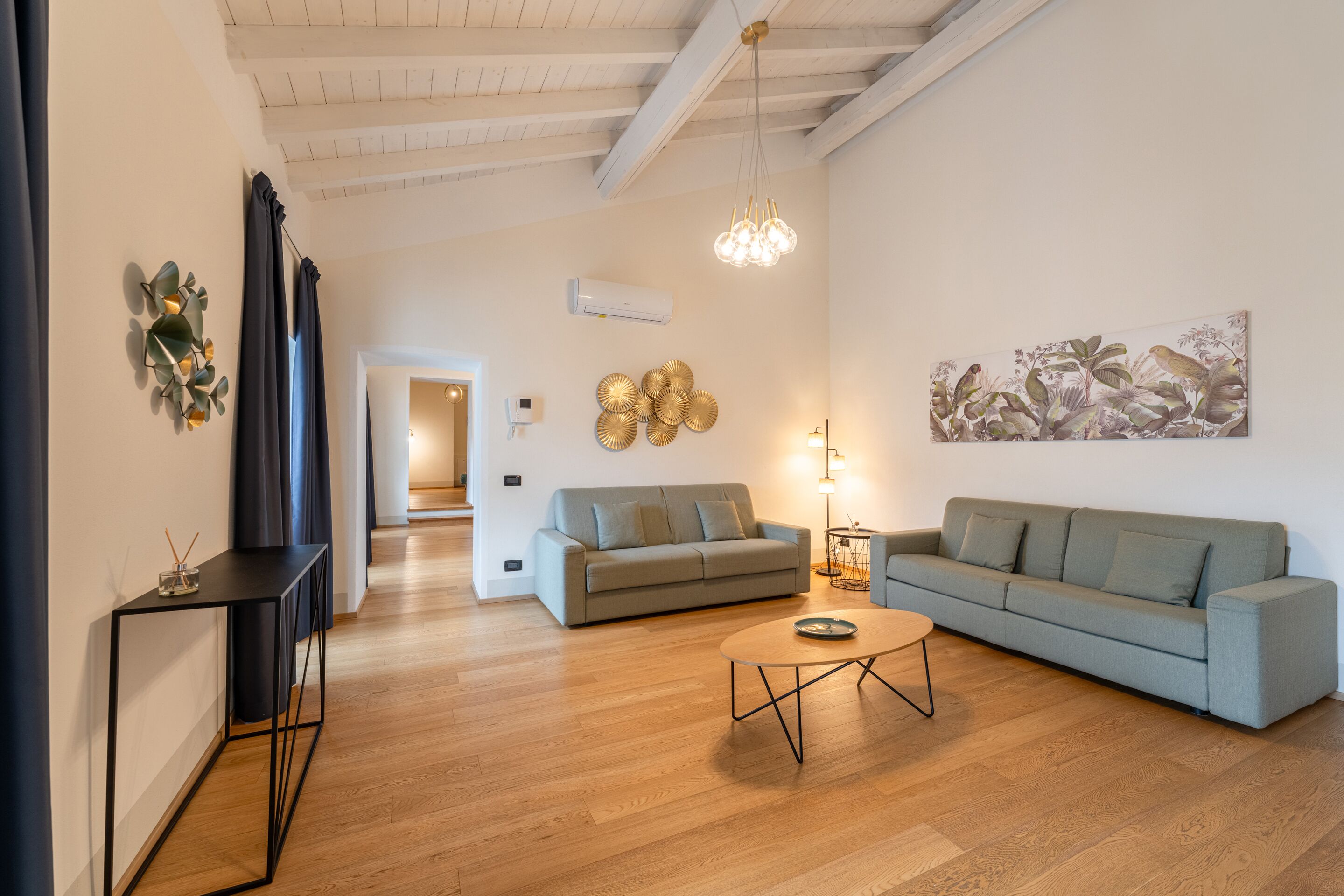 A modern living room with a sofa, coffee table, and decorative wall art.