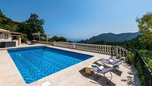 A swimming pool with lounge chairs, a pergola, and a view of the mountains. - Villa Les Adrets Mandelieu Hillside With Pool - 2303 (Fréjus)
