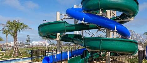 A water park with multiple slides and a pool.