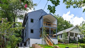 A modern two-story house with a balcony and a covered porch. - Create amazing stories in the treetops of Atlanta! (Atlanta)