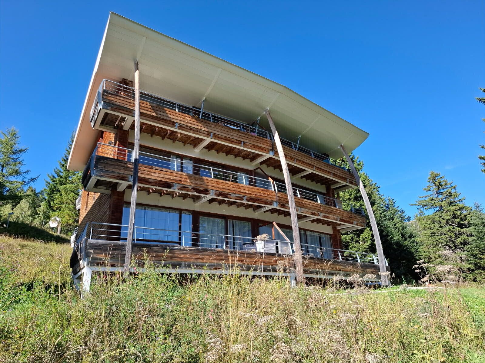 A multi-story building with a wooden facade and balconies.