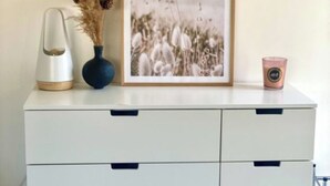 A white dresser with three drawers and a framed picture of a field. - Château Juliette 4* Provence wine estate (Tresques)