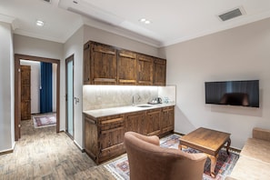 Deluxe Suite, Garden View | Private kitchen | Mini-fridge, electric kettle, highchair