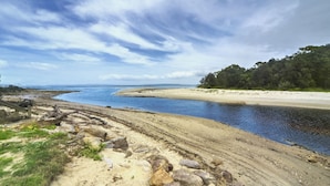 A coastal landscape with a sandy beach, a river, and a forested area. - Callala Bay n Beach House - Pet Friendly with Fireplace (Callala Bay)