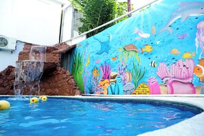 A swimming pool with a mural of marine life and a waterfall feature. - Hotel Paraiso Acapulco (Acapulco)