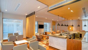 A modern hotel lobby with seating areas, a reception desk, and a large TV screen. - Park Inn By Radisson Lucknow Vikas Nagar (Lucknow)