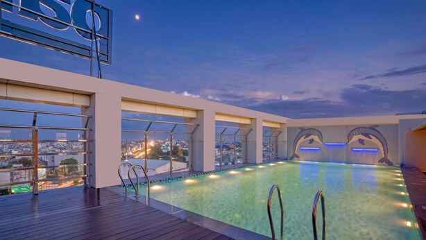 A rooftop infinity pool with a city view, large windows, and a sign. - Park Inn By Radisson Lucknow Vikas Nagar (Lucknow)
