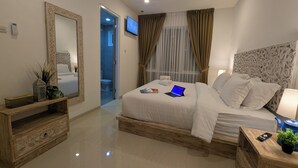 A modern bedroom with a large bed, a TV, and a wooden nightstand. - Azura Villas Nusa Dua Bali (Nusa Dua)