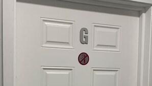 A white door with a 'G' and a no-smoking sign. - The Castle ᴳ (Philipsburg)