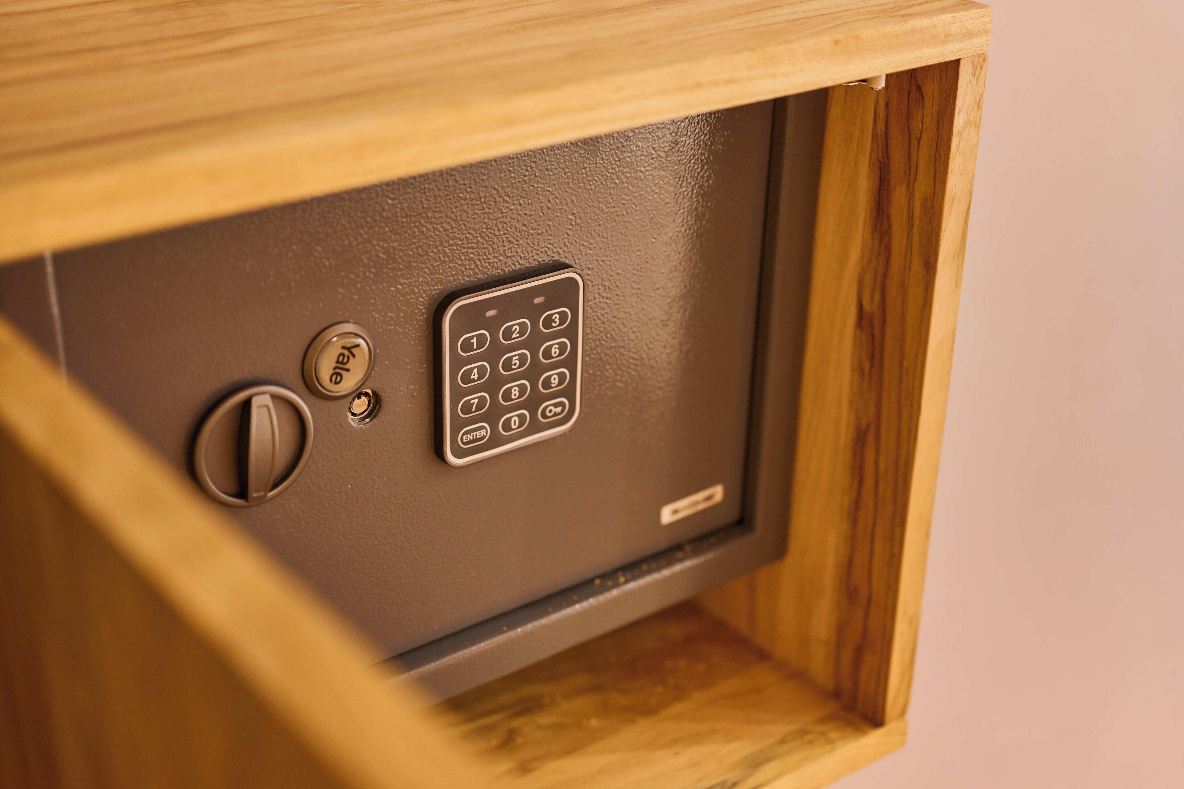 A safe with a keypad and a keyhole.