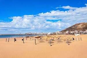 On the beach, sun loungers, beach umbrellas