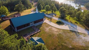 An aerial view of a lodge with a large building, a dock, and a lake. - Timber Lodge Ranch - The Ranch (Amity)