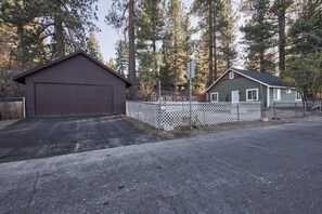 A two-story house with a garage and a fenced yard.
