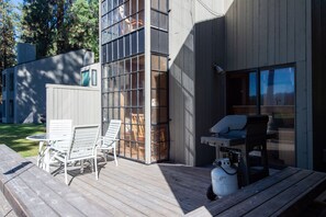 Un bâtiment moderne doté d’une terrasse comprenant un espace salon extérieur et un coin barbecue.