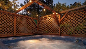 Ein Whirlpool mit Holzverkleidung und Lichterketten.