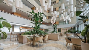 A spacious lobby with high ceilings, modern lighting fixtures, and multiple seating areas. - Brickell Sea View 2BR Free Parking by Palermo Home (Miami)