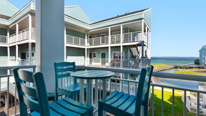 A multi-story building with balconies overlooking a beach. - Baywatch H3 (Pensacola Beach)
