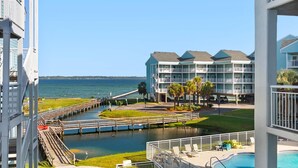 A beachfront hotel with a pool, a dock, and a view of the ocean. - Baywatch H3 (Pensacola Beach)