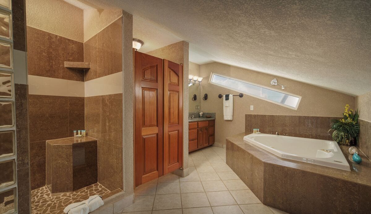 A modern bathroom with a large bathtub, a shower area, and a vanity with a sink.