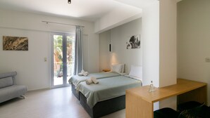 A modern bedroom with a bed, a desk, and a sofa. - Secret Nest 13 , studio,near the beach,Plakias (Plakias)