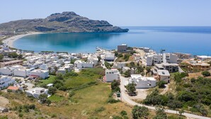 A coastal town with white buildings, a clear blue sea, and a hill in the background. - Secret Nest 13 , studio,near the beach,Plakias (Plakias)