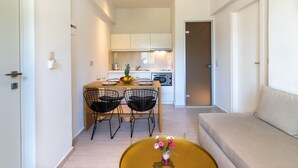 A compact living space with a dining area, kitchenette, and a sofa. - Secretnest 15, apartment near the beach,Plakias (Plakias)