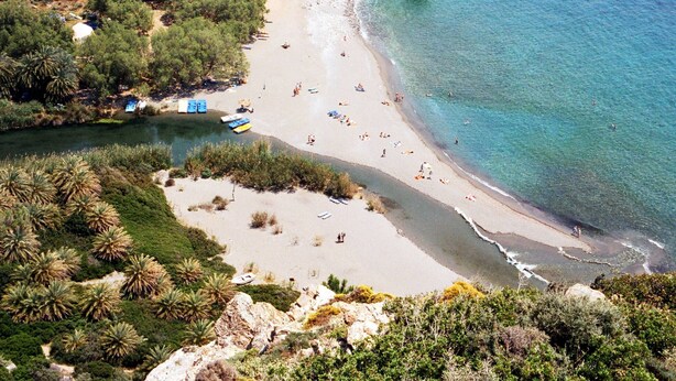 A beach with clear waters, rocky cliffs, and sparse vegetation. - Secretnest 15, apartment near the beach,Plakias (Plakias)