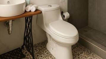 A bathroom with a sink, toilet, and shower.