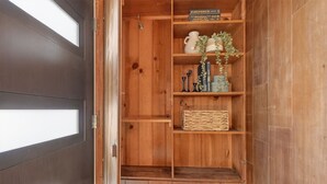A wooden interior with a built-in shelf unit containing decorative items and a book titled "Firepower". - Mid-Century Hideaway, Near Forest Park (Portland)