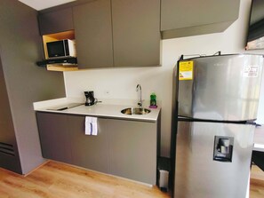 Fridge, microwave, coffee/tea maker, cookware/dishes/utensils