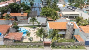 A residential area with a swimming pool, solar panels, and a church.