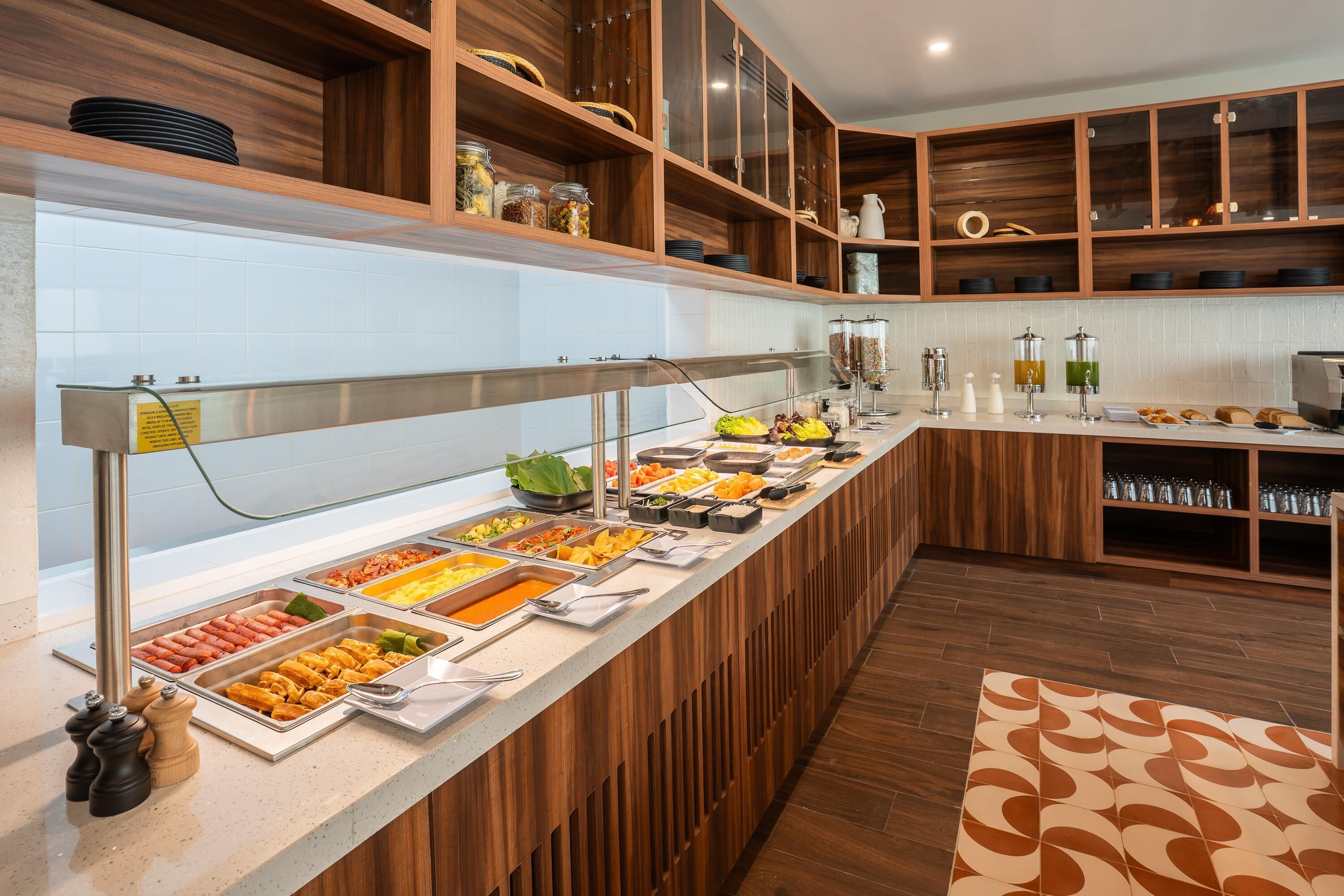 A buffet setup with various food items and a coffee station.