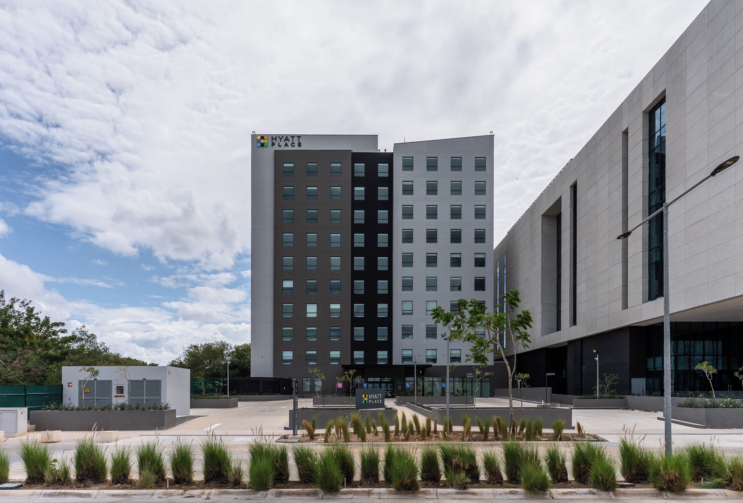 A modern building with a sign reading "HYATT PLACE" on the top.