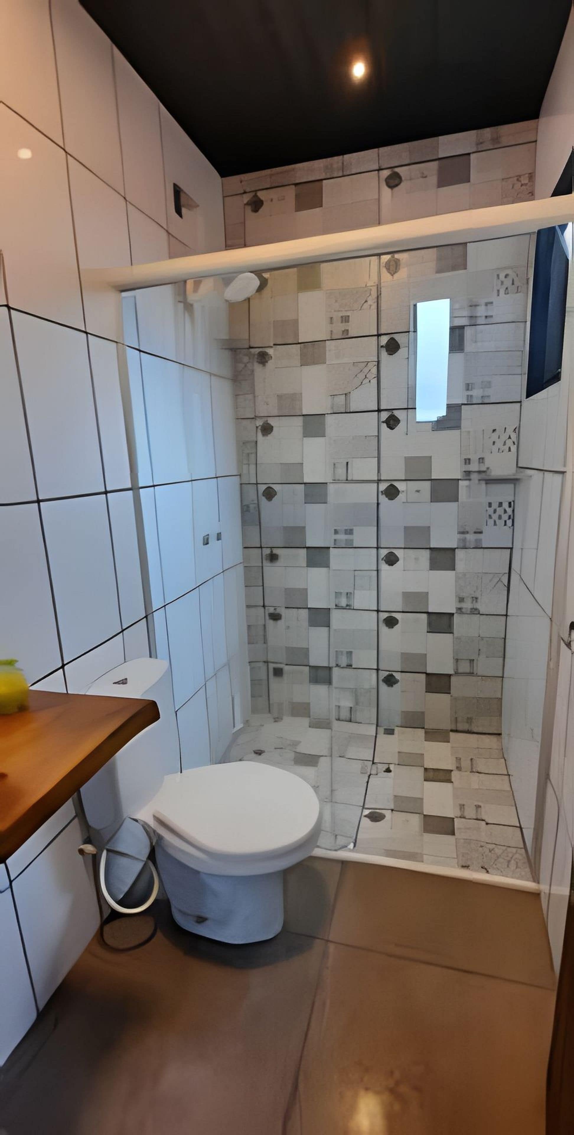 A modern bathroom with a shower, toilet, and a wooden vanity.