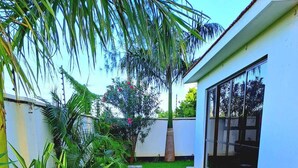 A well-maintained lawn with a pathway leading to a building with large windows. - Nova Stays 1-Bedroom Apartment with Private Pool & Uninterrupted Seaview (Mombasa)