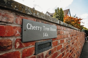 A brick wall with a sign reading "Cherry Tree House 14A". - Boutique Shrewsbury Suites (Shrewsbury)